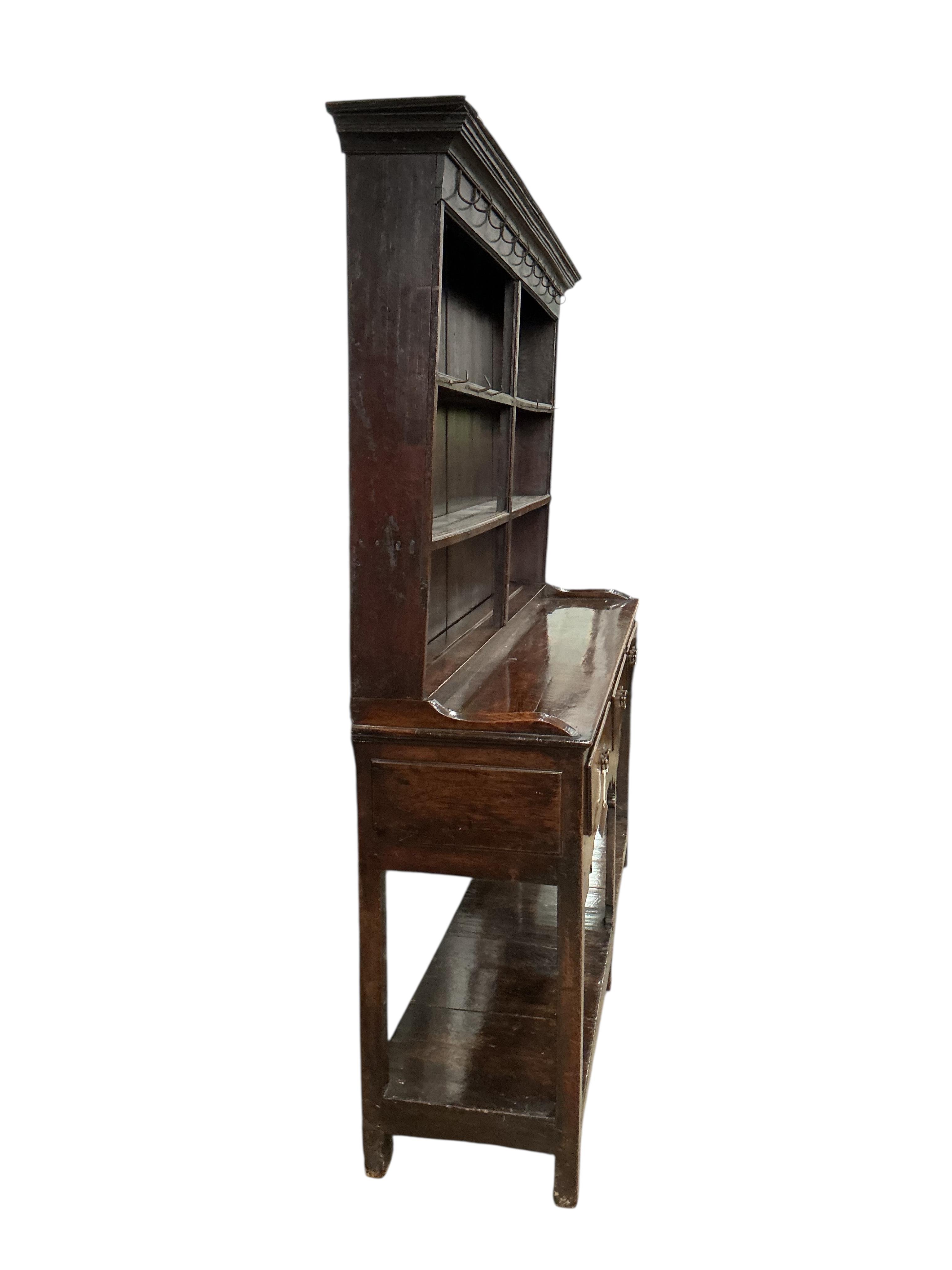 An 18th century oak and pine potboard dresser, with boarded rack, width 169cm, depth 43cm, height 187cm